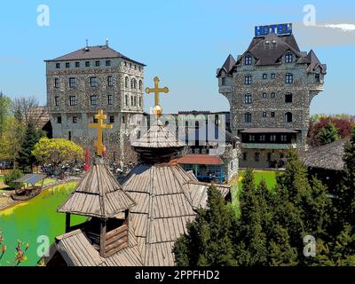 Stanisici, Bijelina, Republika Srpska, Bosnia and Herzegovina April25 2021 Ethno village, tourism and attractions. Stone and wooden buildings of the hotel. People visit restaurant, traditional houses Stock Photo