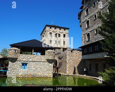 Stanisici, Bijelina, Republika Srpska, Bosnia and Herzegovina April25 2021 Ethno village, tourism and attractions. Stone and wooden buildings of the hotel. People visit restaurant, traditional houses Stock Photo