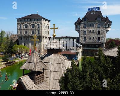 Stanisici, Bijelina, Republika Srpska, Bosnia and Herzegovina April25 2021 Ethno village, tourism and attractions. Stone and wooden buildings of the hotel. People visit restaurant, traditional houses Stock Photo