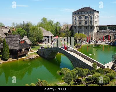 Stanisici, Bijelina, Republika Srpska, Bosnia and Herzegovina April25 2021 Ethno village, tourism and attractions. Stone and wooden buildings of the hotel. People visit restaurant, traditional houses Stock Photo