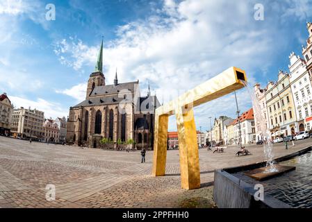 Plzen (Pilsen), Czech Republic - May 05, 2022: St. Bartholomew's Cathedral in the main square of Plzen with a fountain on the foreground Stock Photo