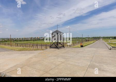 Majdanek Nazi concentration and extermination camp, view of wooden guard tower and barbed wire fence, Lublin, Poland Stock Photo