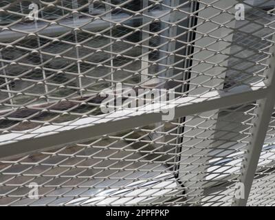 New white frames and windows. Metal fence for the safety of schoolchildren. New modern school. View from the window to the opposite wall and windows. Security systems. Internal office interior. Stock Photo