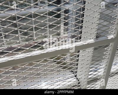New white frames and windows. Metal fence for the safety of schoolchildren. New modern school. View from the window to the opposite wall and windows. Security systems. Internal office interior. Stock Photo