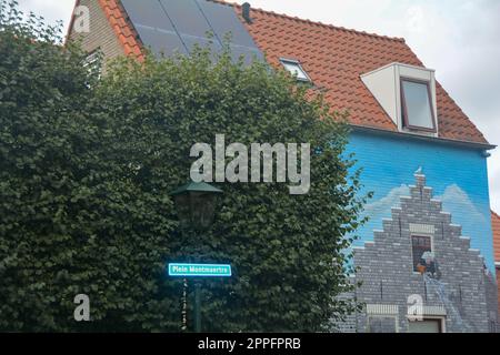 Zierikzee, Zeeland, The Netherlands , August 27th 2020 - Ornate mural at Plein Montmaertre with hedge and street sign Stock Photo