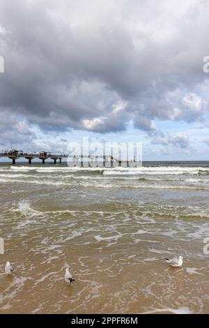 Miedzyzdroje pier, long wooden jetty entering the Baltic Sea from the beach, beautiful seaside landscape, Miedzyzdroje, Poland Stock Photo