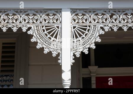 Detail of the facade of a traditional colonial residential house with wrought iron porch posts and railings, Melbourne, Victoria, Australia Stock Photo