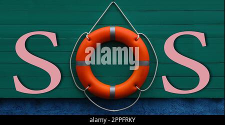 SOS message made from lifebuoy and pink letters on green wooden board. Banner design Stock Photo