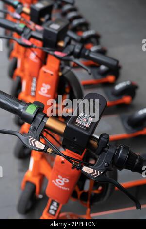 Row of shared Electric Kick Scooters or e-steps seen from above for rent are waiting for customers in a street in Melbourne, Australia. E-mobility Stock Photo
