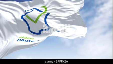 The flag of Hauts de France region waving in the wind on a clear day Stock Photo
