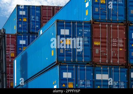 Close-up blue and red logistic container. Cargo and shipping business. Container ship for import and export logistics. Logistic industry. Container for truck transport. Freight transportation concept. Stock Photo