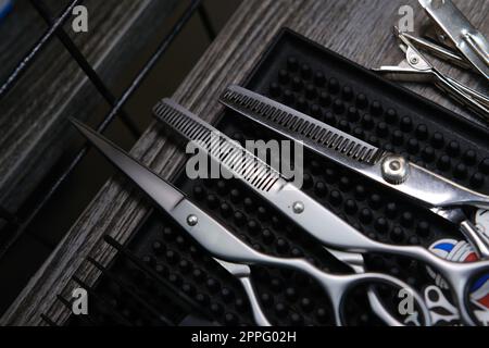 Vintage barber shop tools on old wooden background and rubber mat Stock Photo