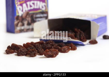 Pile of Raisins With Box Isolated on White Background Stock Photo
