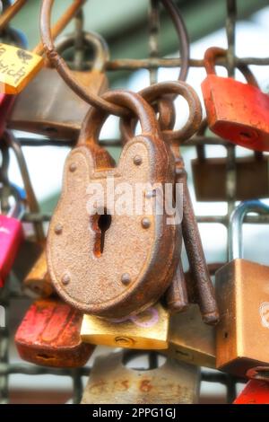 Love lock as a symbol of love and unity hanging on a bridge railing Stock Photo