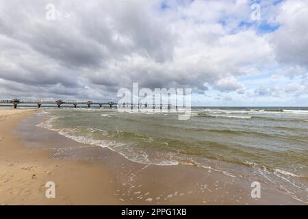 Miedzyzdroje pier, long wooden jetty entering the Baltic Sea from the beach, Wolin Island, Miedzyzdroje, Poland Stock Photo