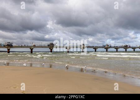 Miedzyzdroje pier, long wooden jetty entering the Baltic Sea from the beach, Wolin Island, Miedzyzdroje, Poland Stock Photo