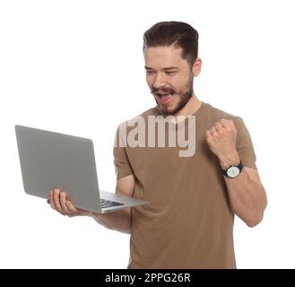 Emotional man with laptop on white background Stock Photo