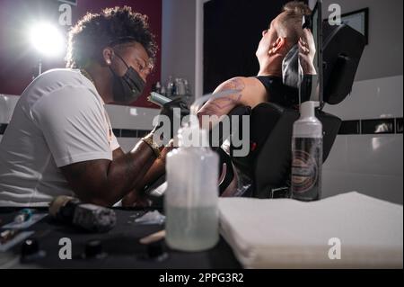 Body art at the tattoo studio Stock Photo