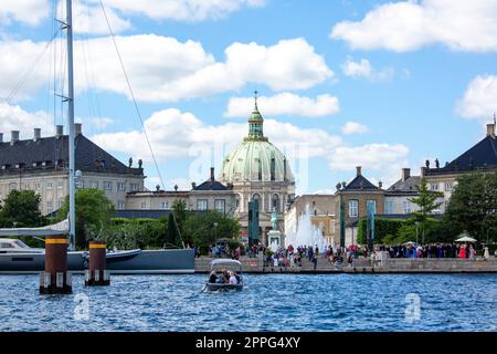Tourists at the Amaliehaven fountain, Marble Church and statue of King Frederik V, Copenhagen, Denmark Stock Photo