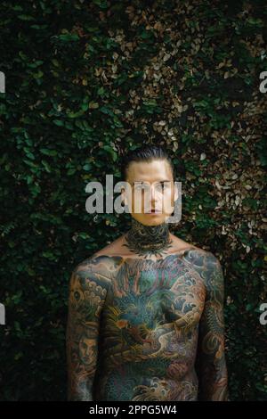Handsome man with tattoos in Japanese style. Stock Photo