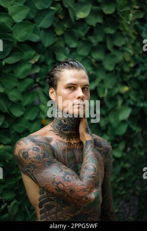 Young handsome man with tattoos in Japanese style. Stock Photo