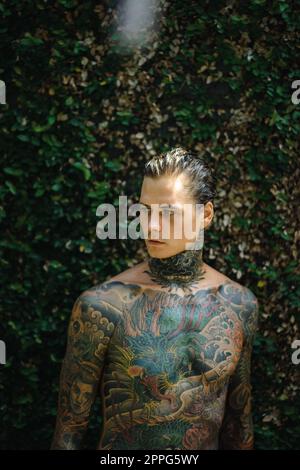 Handsome man with tattoos in Japanese style. Stock Photo