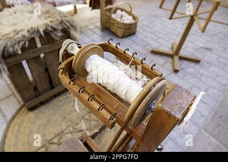 Spinning Wheel For Making Yarn From Wool Fibers. Vintage Rustic Equipment  Stock Photo - Alamy