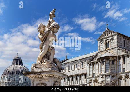 Angel statues of marble Putti fountain in Piazza dei Miracol iwith Cathedral Duomo di Pisa. Stock Photo