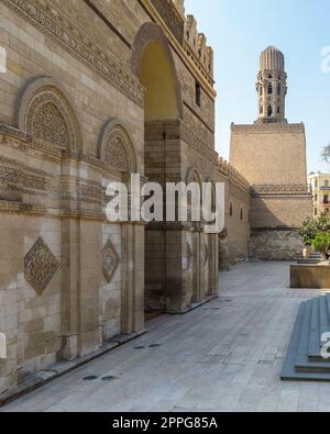 Entrance of public historic Al Hakim Mosque - Enlightened Mosque - and Minaret, Moez Street, Cairo Stock Photo
