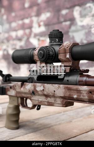 Closeup view of modern powerful sniper rifle with telescopic sight outdoors Stock Photo
