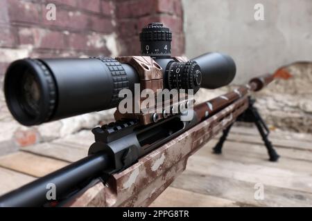 Closeup view of modern powerful sniper rifle with telescopic sight outdoors Stock Photo