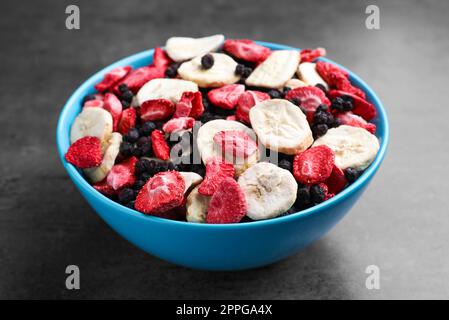 Bowl of dried fruits on grey table, closeup Stock Photo