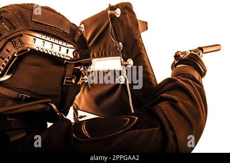 Armed SWAT fighter hiding behind ballistic shield Stock Photo