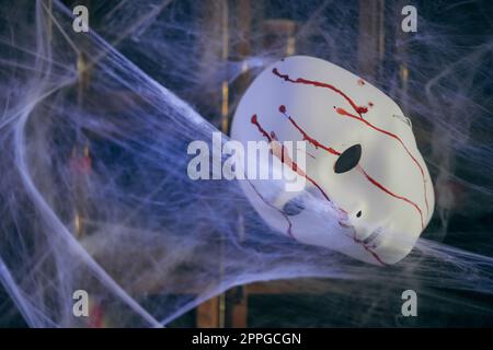 Color image of a white mask, painted with blood Stock Photo