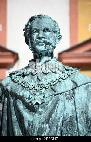 The monument to King Maximilian II of Bavaria stands in front of the Old Palace in Bayreuth on the courtyard. The statue of the Maximilian monument was cast in 1860 and stands on a granite base. Stock Photo