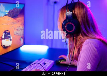 Young player woman wearing gaming headphones intend to do playing live stream games online Stock Photo