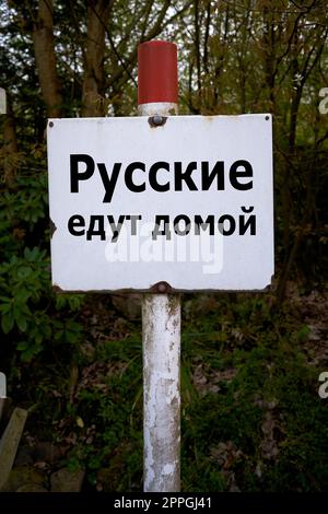 Sign in Russian language in a forest with the inscription Russians go home Stock Photo
