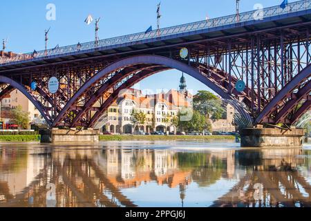 Old Bridge and Lent district in Maribor, Slovenia. Popular waterfront promenade with historical buildings and the oldest grape vine in Europe. Stock Photo