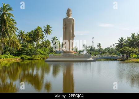 Large standing Buddha near Hikkaduwa reminds to the Tsunami disaster in 2004 Stock Photo