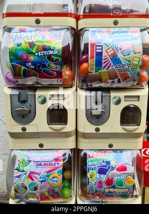 Hamburg, Germany - 03 September 2022: Two old vintage chewing gum vending machines on a street. Stock Photo