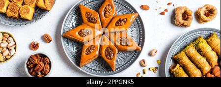 Arabian Baklava with nuts and honey on white background, banner. Ramadan dessert - fresh assorted nut baklava. Stock Photo