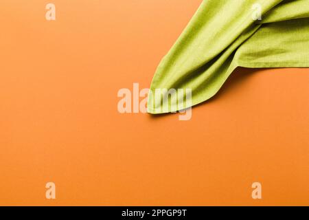top view with green kitchen napkin isolated on table background. Folded cloth for mockup with copy space, Flat lay. Minimal style. Stock Photo