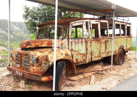 Rusty old 1970’s school bus, Episkopi village, near Paphos, Republic of Cyprus Stock Photo