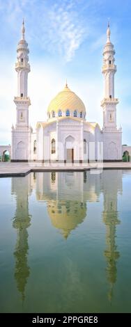 White Mosque, Bolgar, Tatarstan. A beautiful white mosque with domes and minarets against a bright blue sky. Stock Photo