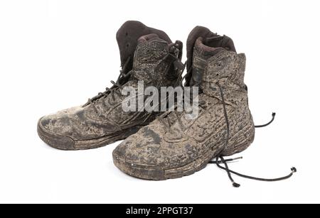 Black shoes, covered in mud, isolated on white Stock Photo - Alamy