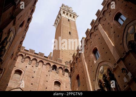 Siena City Hall. View from Palazzo Pubblico courtyard with the imposing tower Torre del Mangia, Siena, Tuscany, Italy. Stock Photo