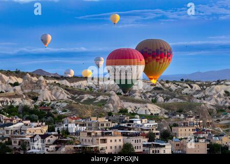 hot air balloon flies over the city of goreme Stock Photo