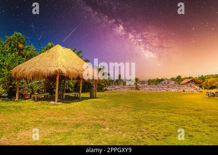Ancient ruins of Maya in El Rey Archaeological Zone near Cancun, Yukatan, Mexico with Milky Way Galaxy stars night sky Stock Photo