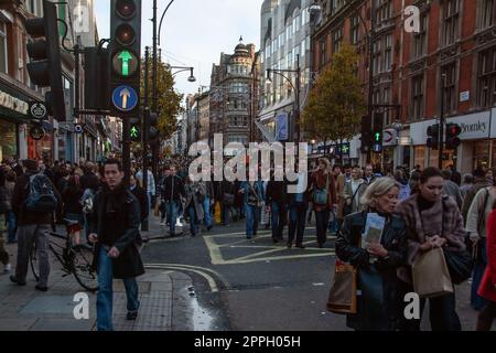 London, United Kingdom - December 2nd, 2006: Tens of thousands pedestrians walking on otherwise very busy road during 'Oxford Street closed for traffic' event.Plans are to pedestrianise it permanently Stock Photo