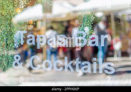 SAN LORENZO DE EL ESCORIAL, SPAIN - OCTOBER 24, 2021: Showcase of a tapas and cocktail bar in San Lorenzo de El Escorial, Spain Stock Photo